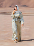 Woman wearing YEZWE modest co-ord set with long sleeves and peplum detail in desert background