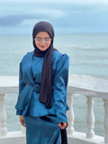 YEZWE Modest Co-Ord Set in teal satin fabric worn with black hijab by the seaside