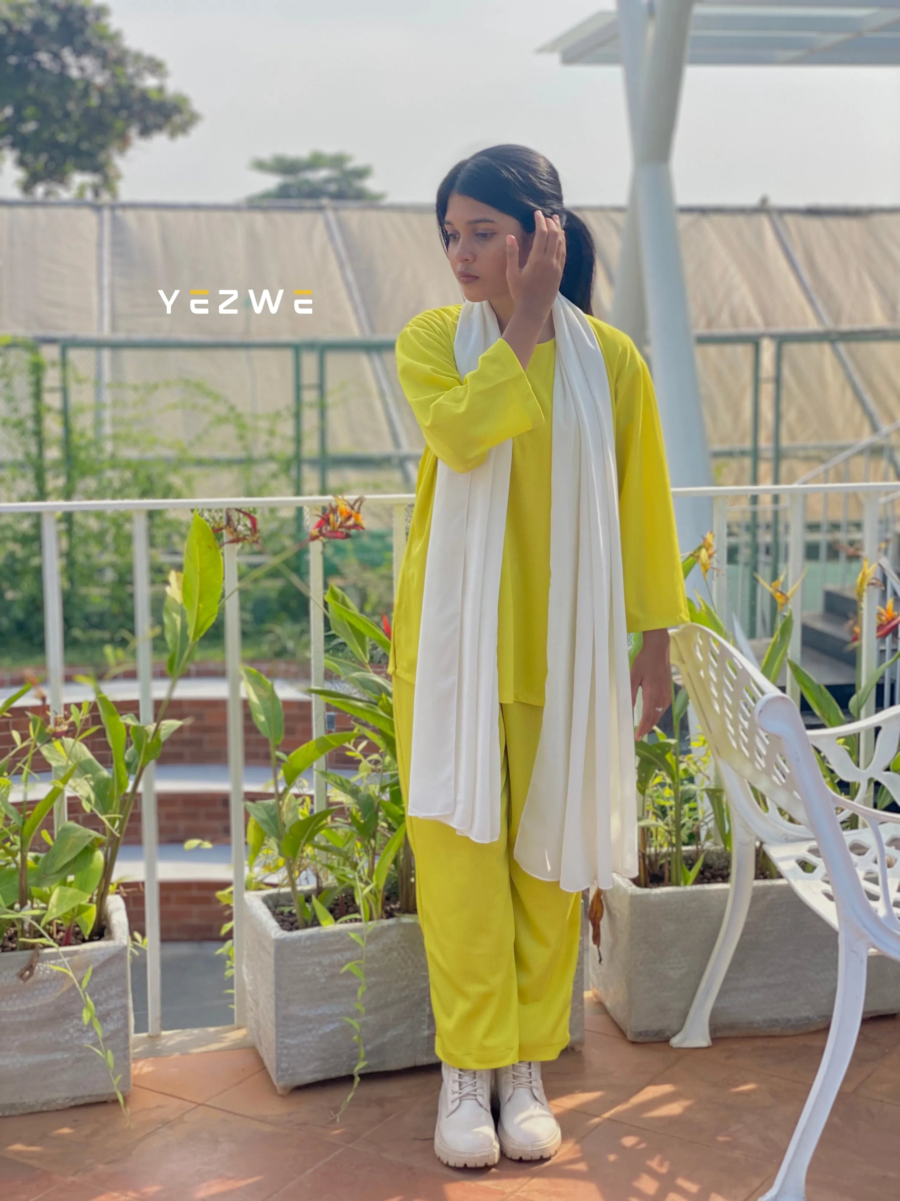 Bright yellow modest fashion co-ord set with long sleeves and matching pants, styled with a white shawl