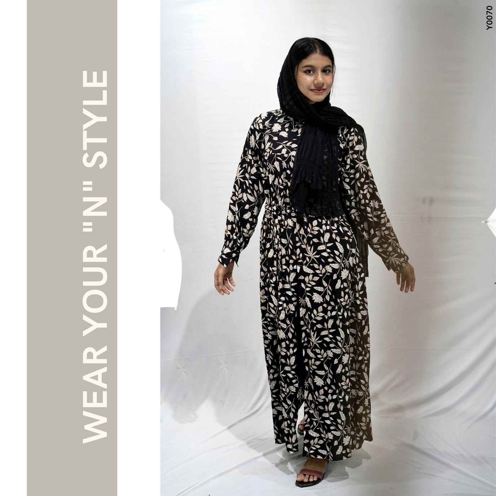 Model wearing a modest floral maxi dress by Yezwe, featuring a black and white floral design with long sleeves