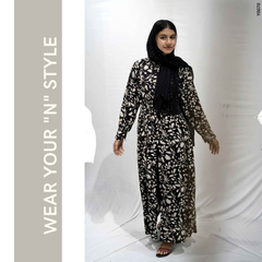 Model wearing a modest floral maxi dress by Yezwe, featuring a black and white floral design with long sleeves