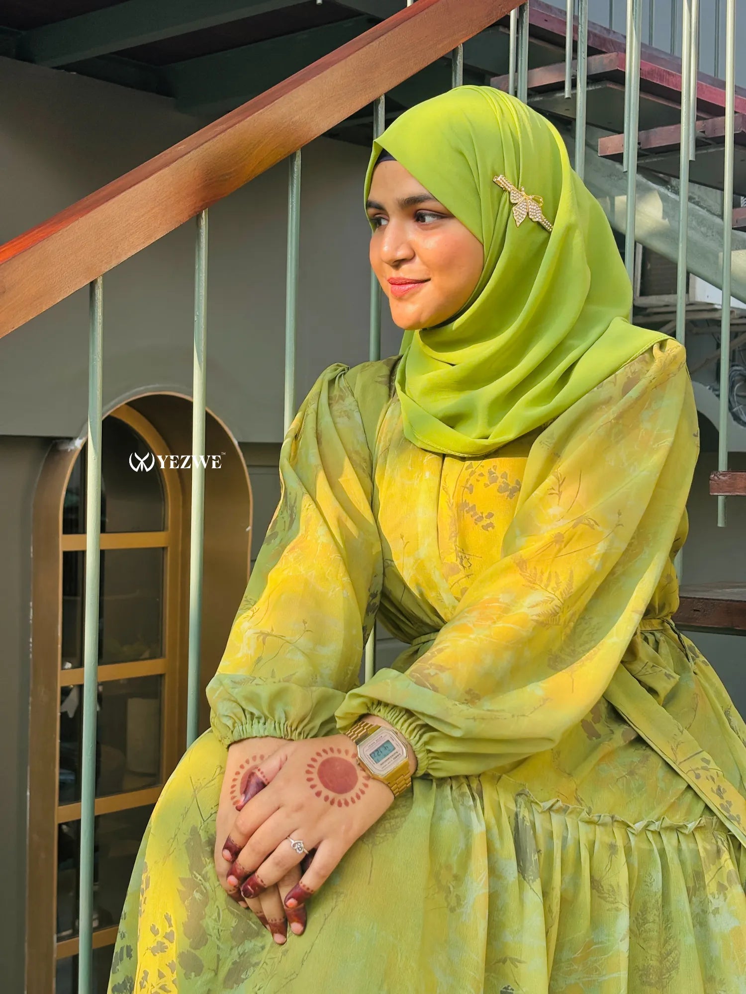 Modest green floral maxi dress by Yezwe styled with a matching hijab and elegant accessories