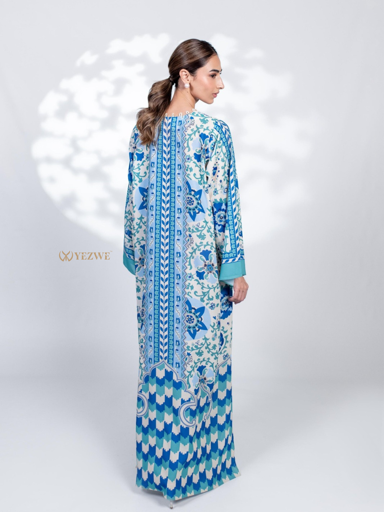Elegant YEZWE Modest Jalabiya Maxi Dress featuring intricate floral patterns in vibrant blue and green colors