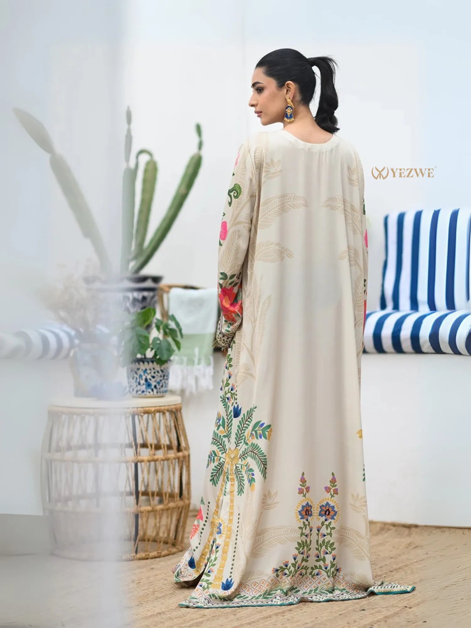 YEZWE Modest Kaftan Dress cream maxi with colorful floral and palm motifs back view woman standing