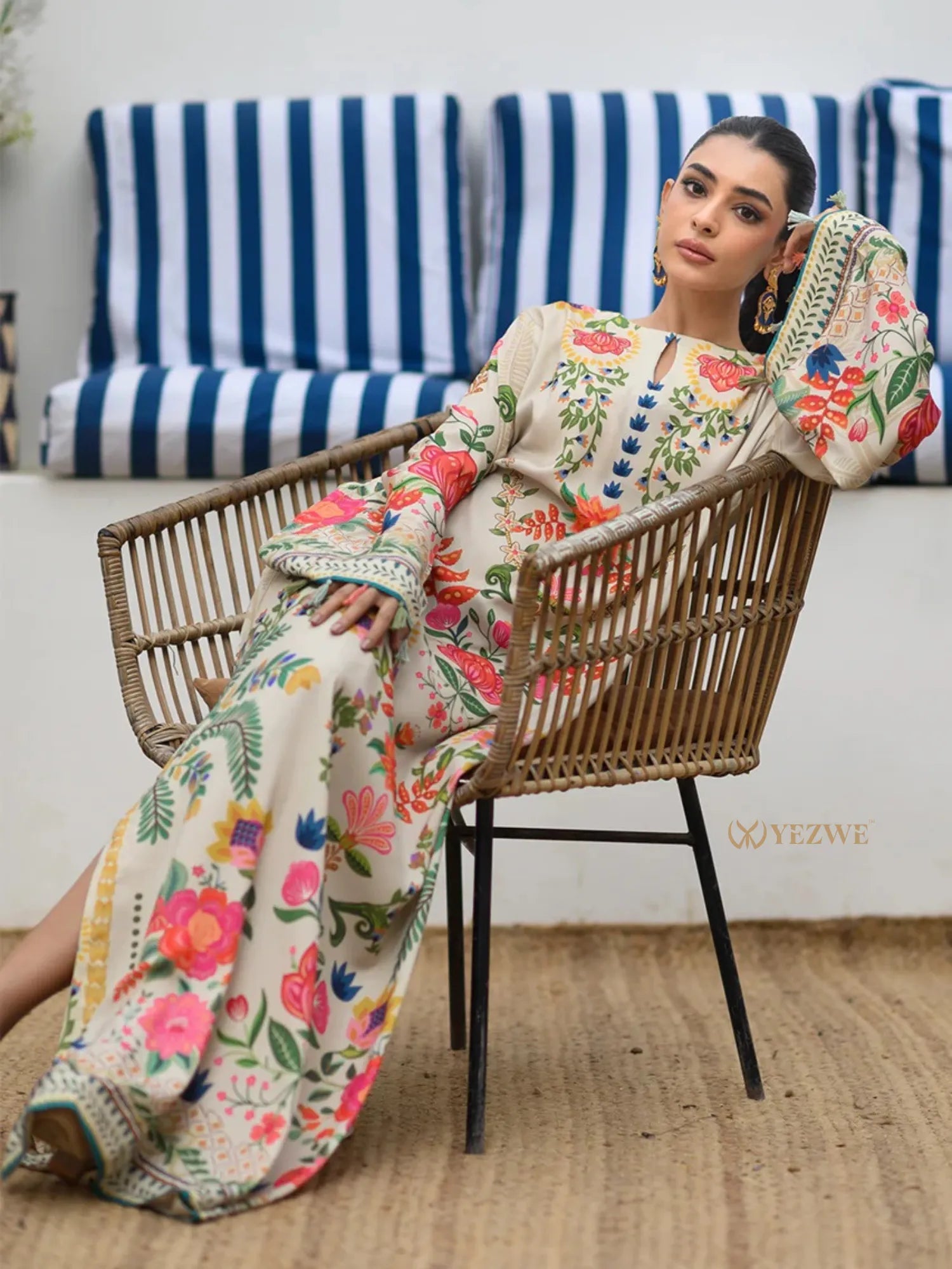 YEZWE Modest Kaftan Dress floral maxi dress with long sleeves model reclining in rattan chair