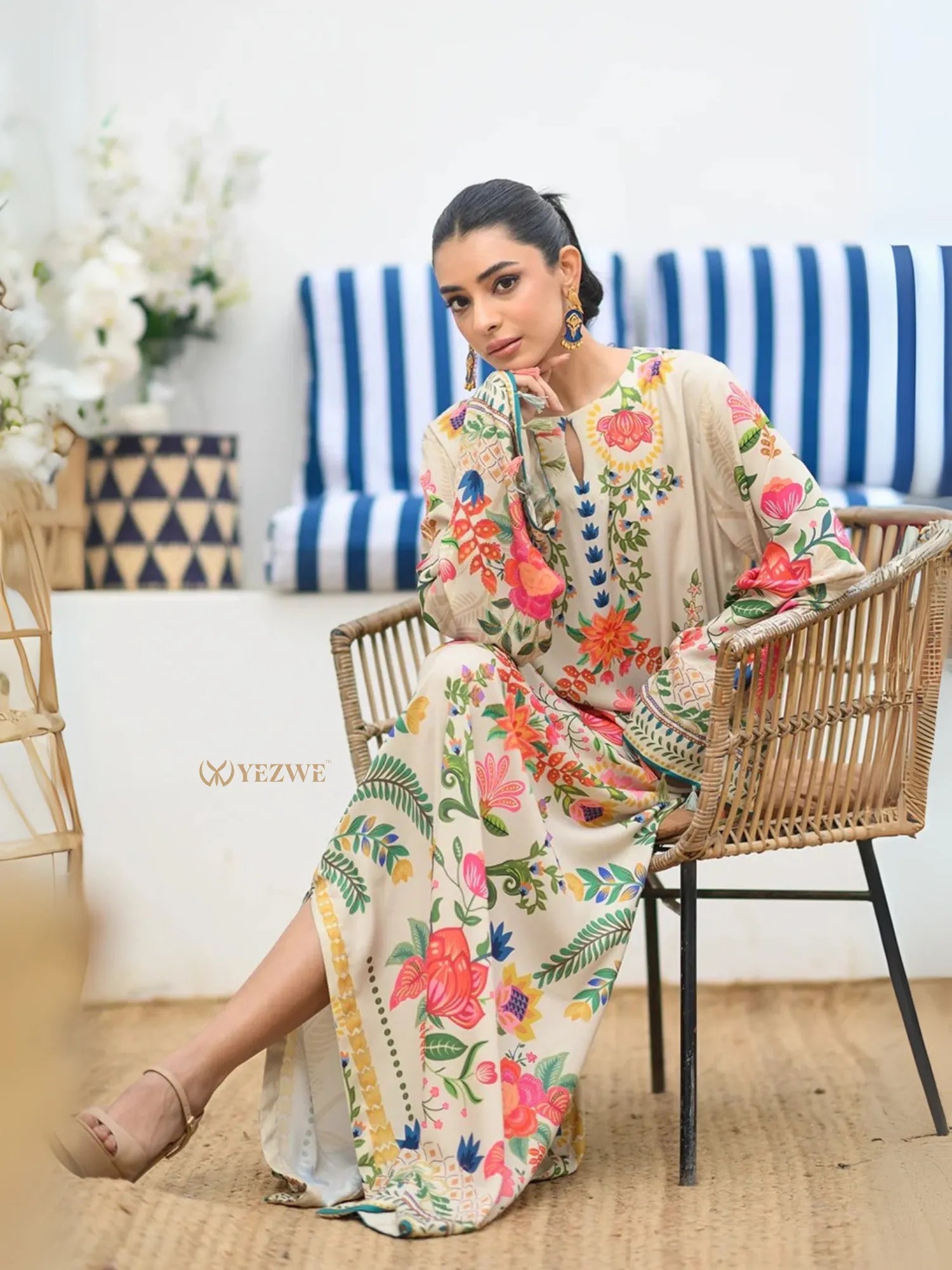 YEZWE Modest Kaftan Dress beige floral maxi dress with long sleeves relaxed fit model seated in rattan chair