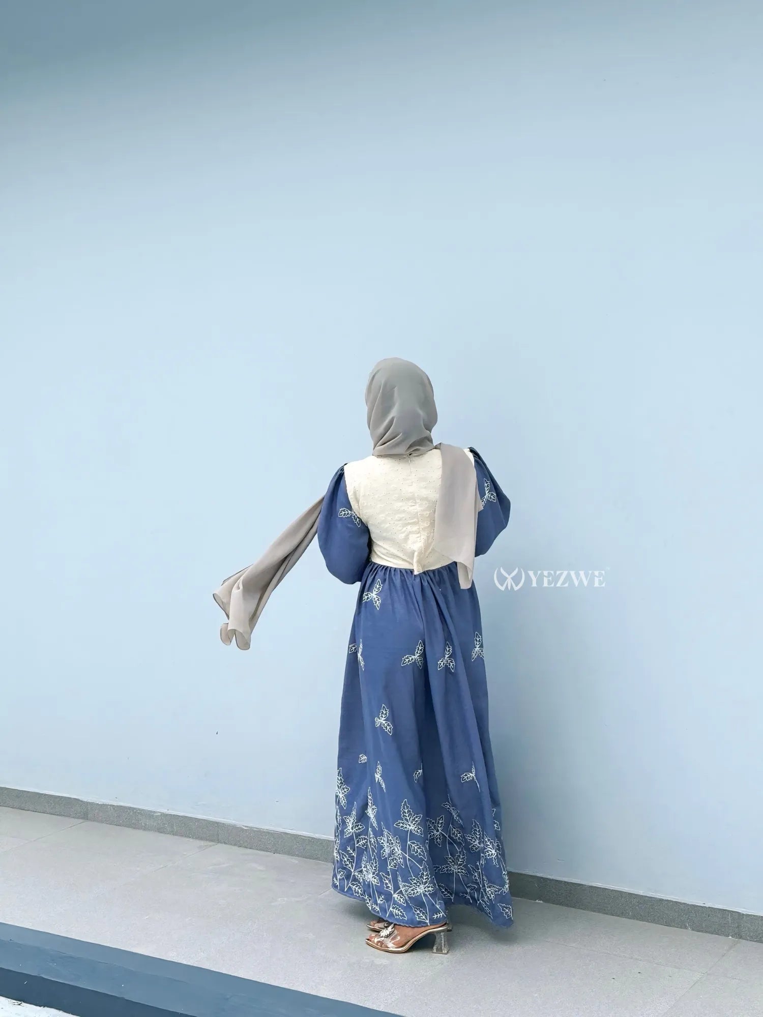 Back view of YEZWE Modest Maxi Dress in blue with elegant floral embroidery