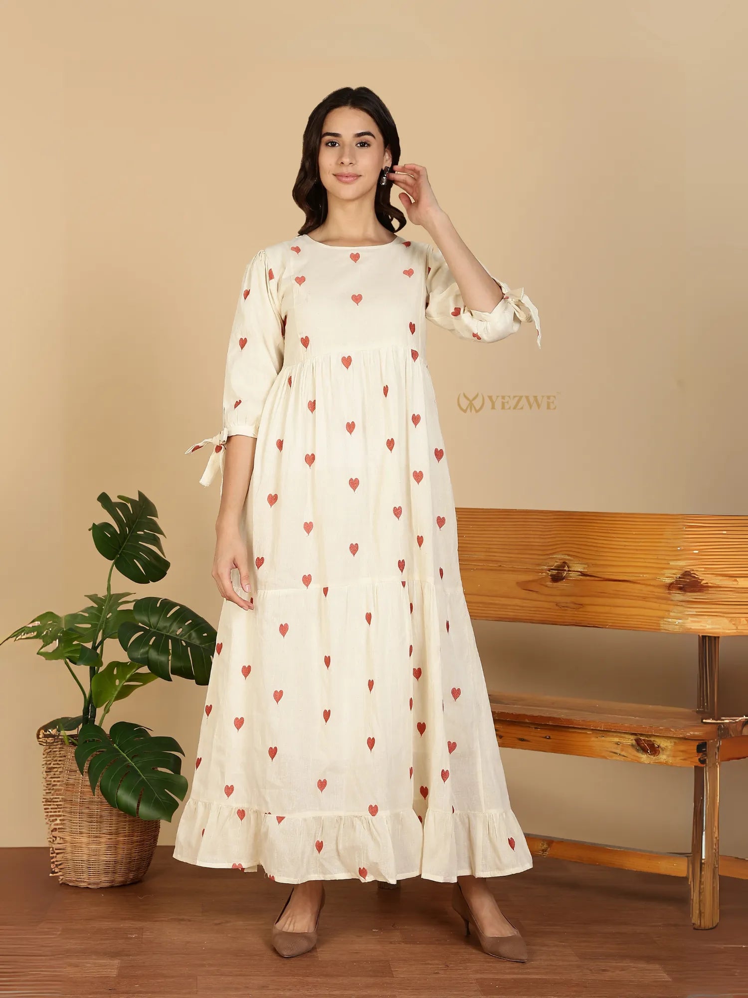 Yezwe Modest Maxi Dress cream tiered heart print long sleeve dress with bow sleeve ties on model
