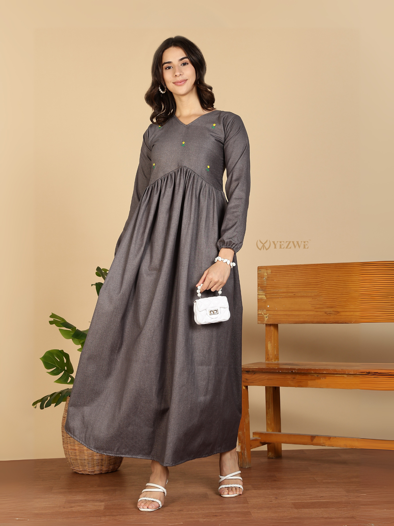 Yezwe Modest Maxi Dress gray long sleeve gathered waist with subtle green embroidery model holding white purse