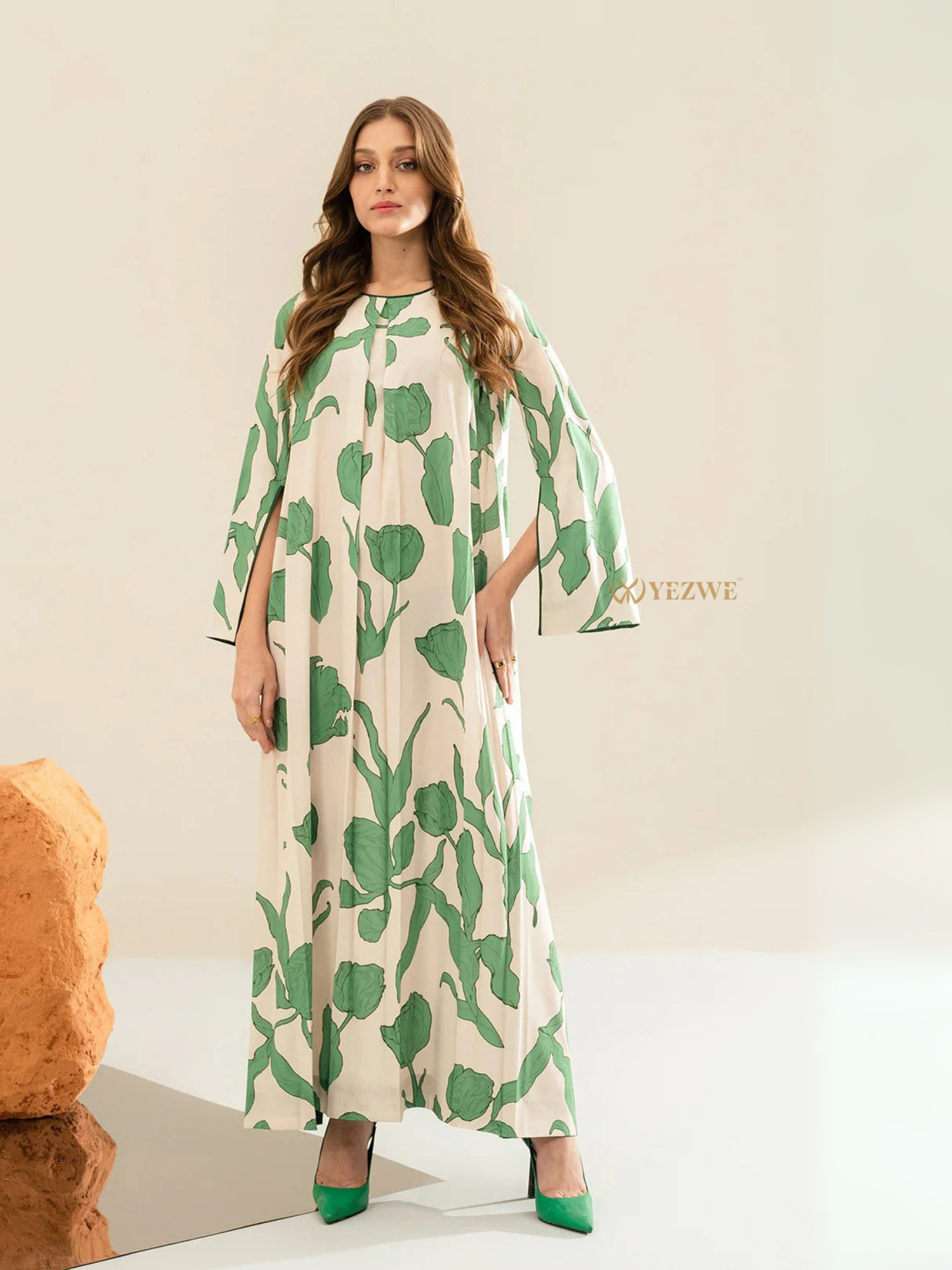 Yezwe modest maxi dress with green leaf print and flowing long sleeves on a female model