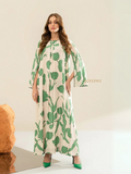 Yezwe modest maxi dress with green leaf print and flowing long sleeves on a female model