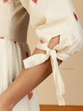 Yezwe Modest Maxi Dress cream puff sleeve close up showing red heart embroidery and tied bow sleeve detail