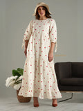 Yezwe modest maxi dress in cream with red heart print worn with a beige hat and brown shoes