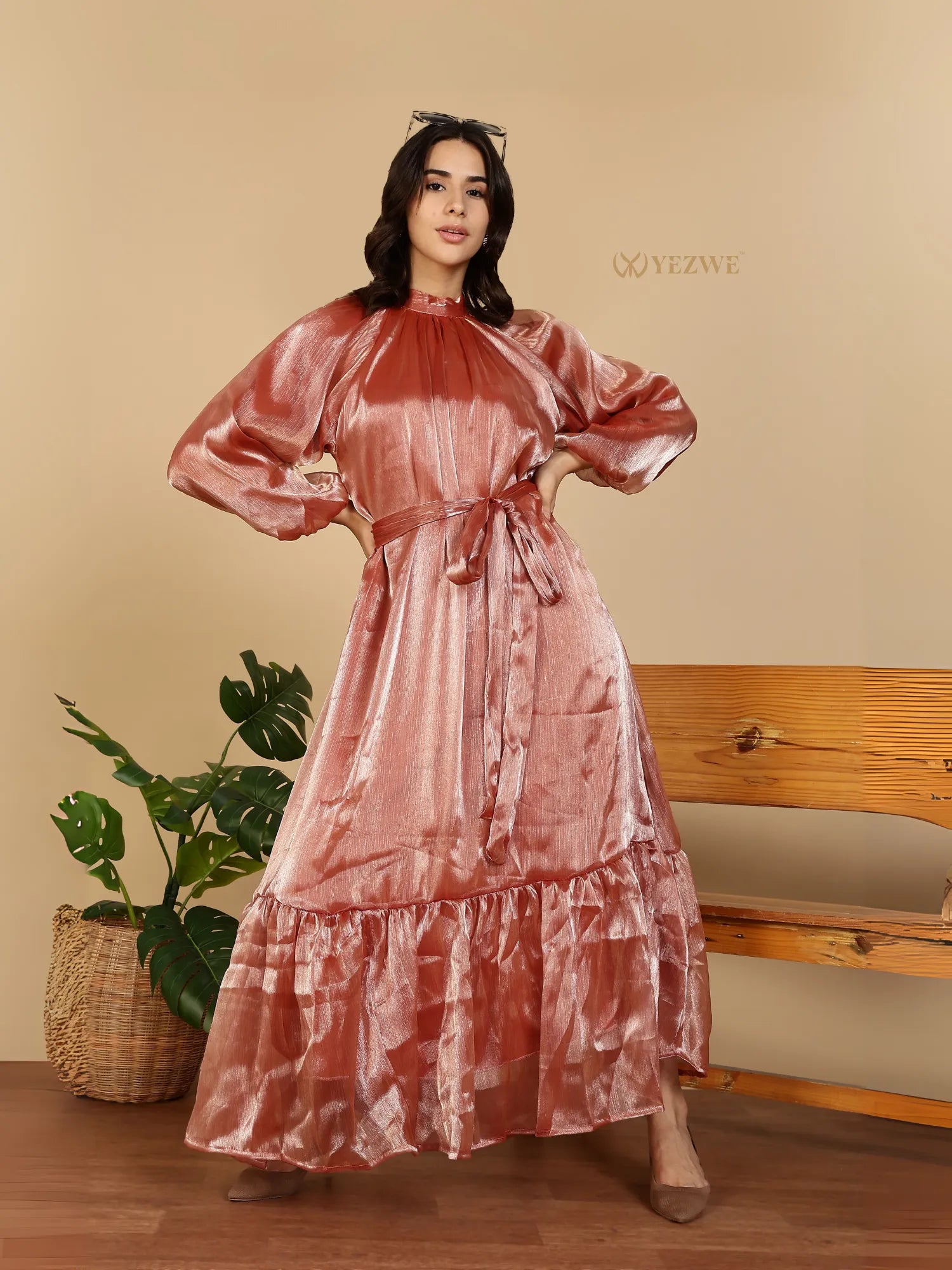 YEZWE Modest Party Wear Maxi Dress rose gold satin long sleeve with tie waist ruffle hem on model