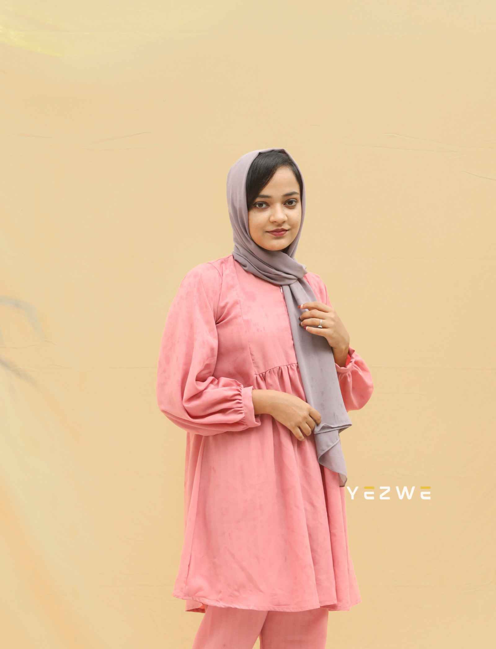 Modest pink co-ord set featuring a long top and matching pants for elegant comfort