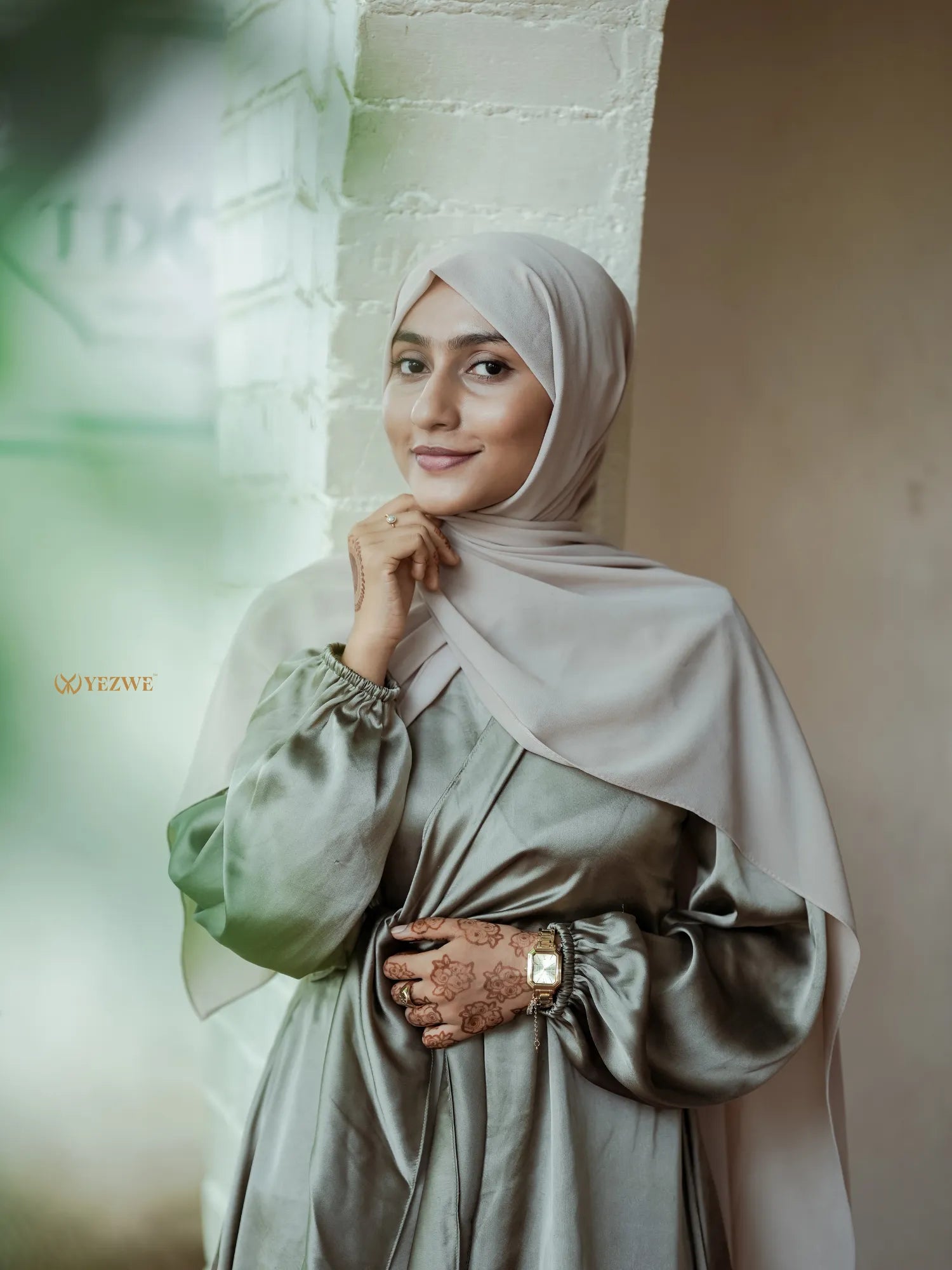 Yezwe modest satin maxi dress in soft green with long sleeves and elegant detailing