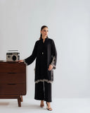 Model wearing YEZWE Modest Wear Black Embroidered Co-ord Set Kurta Set beside vintage speaker on wooden dresser