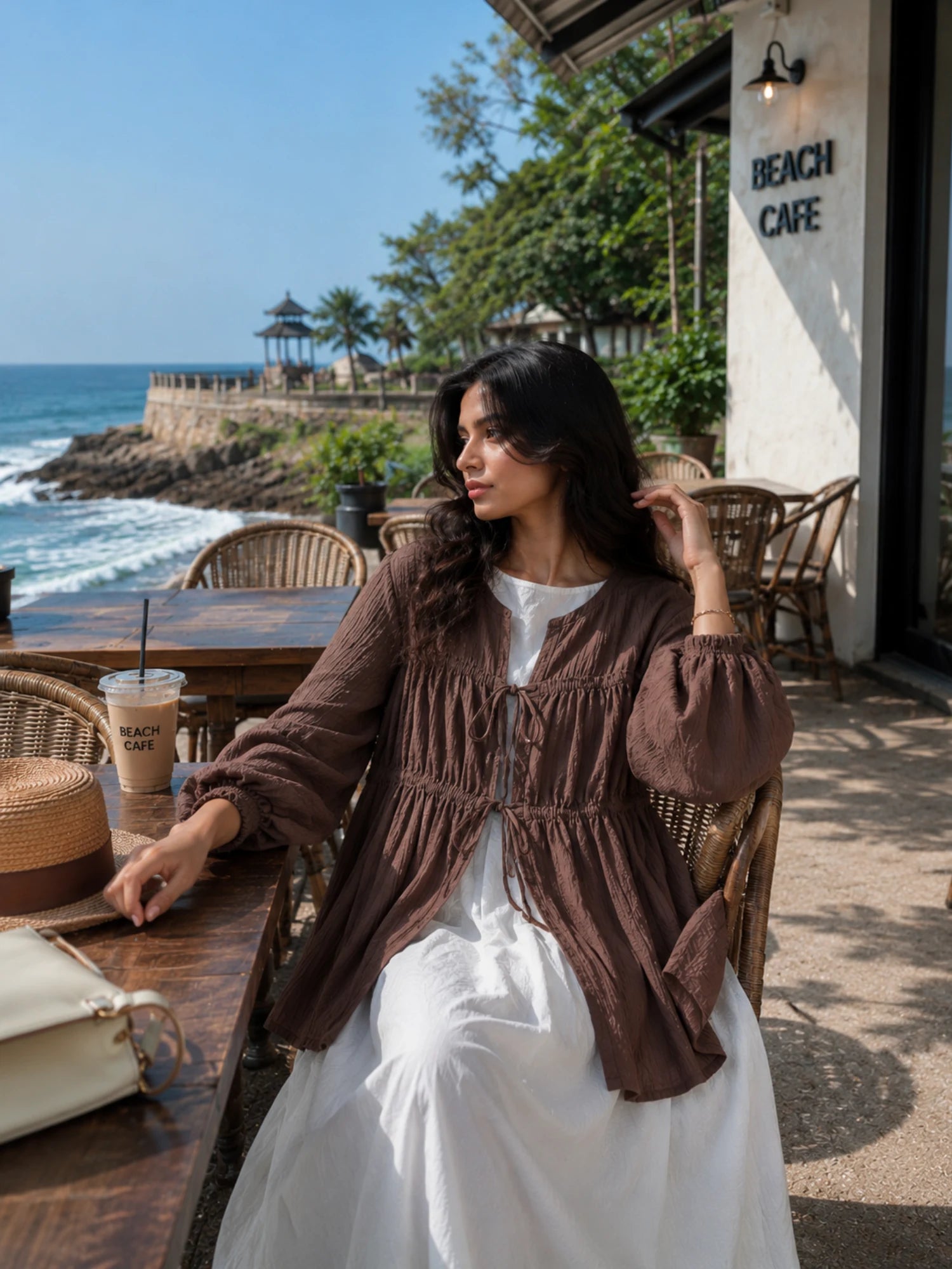 Chocolate Brown Cey Shrug with White Flared Maxi Gown | Yezwe Modest Wear showcased in a beach setting