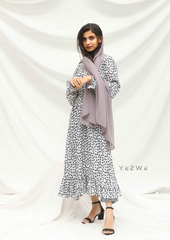 Yezwe modest wear maxi dress in white with black floral print, paired with a gray scarf and stylish black heels