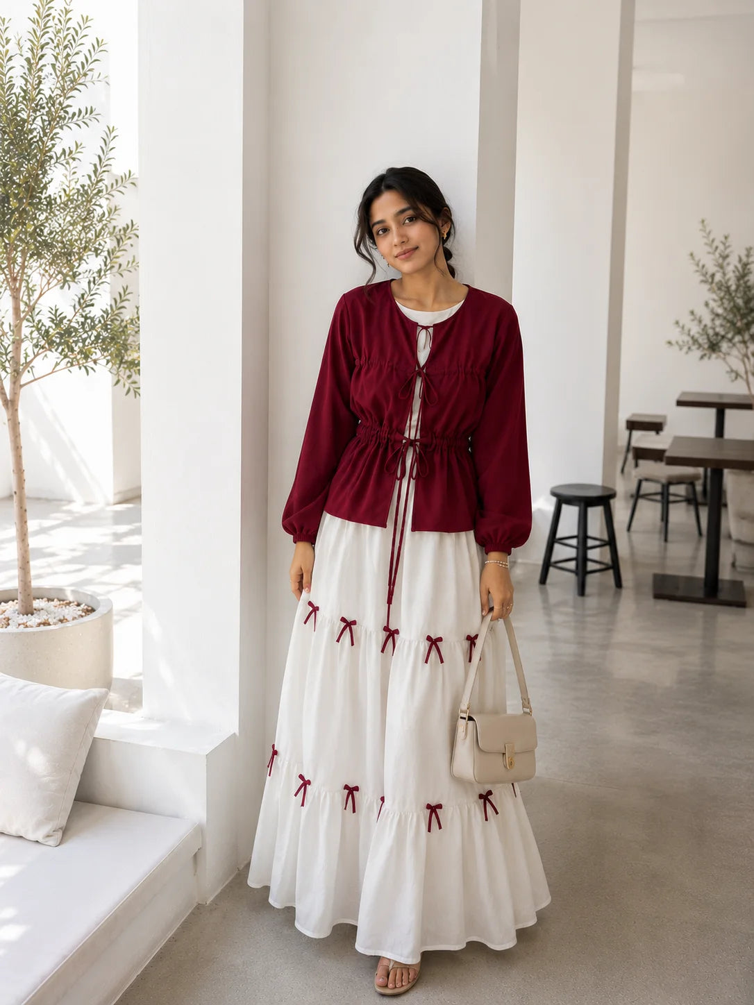 Pinterest Bow Detail White Flared Gown with Wine Cey Shrug | Yezwe Modest Wear in a stylish setting