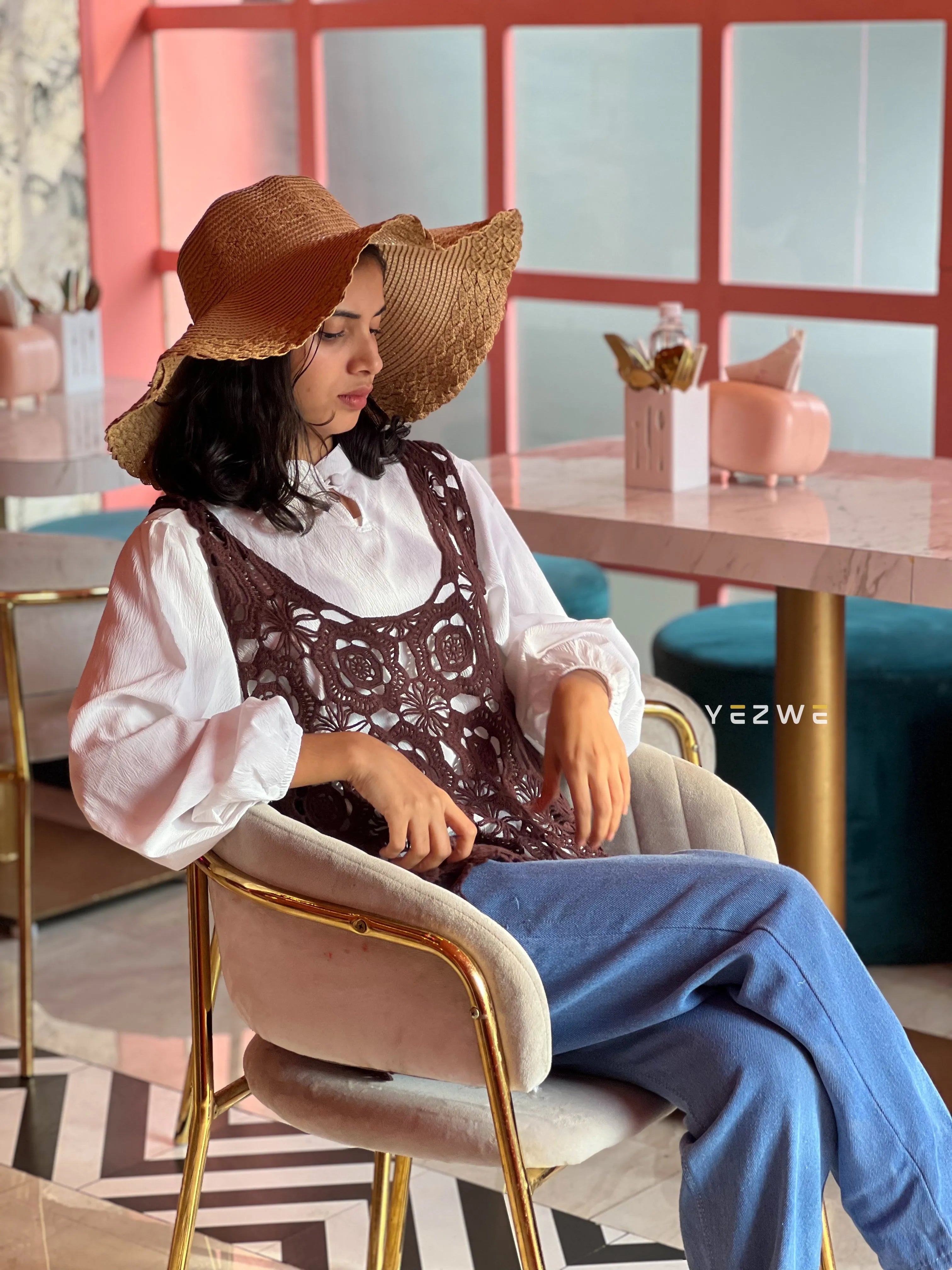 Modest women's shrug from Yezwe styled with a white blouse and wide-brimmed hat for a chic summer look