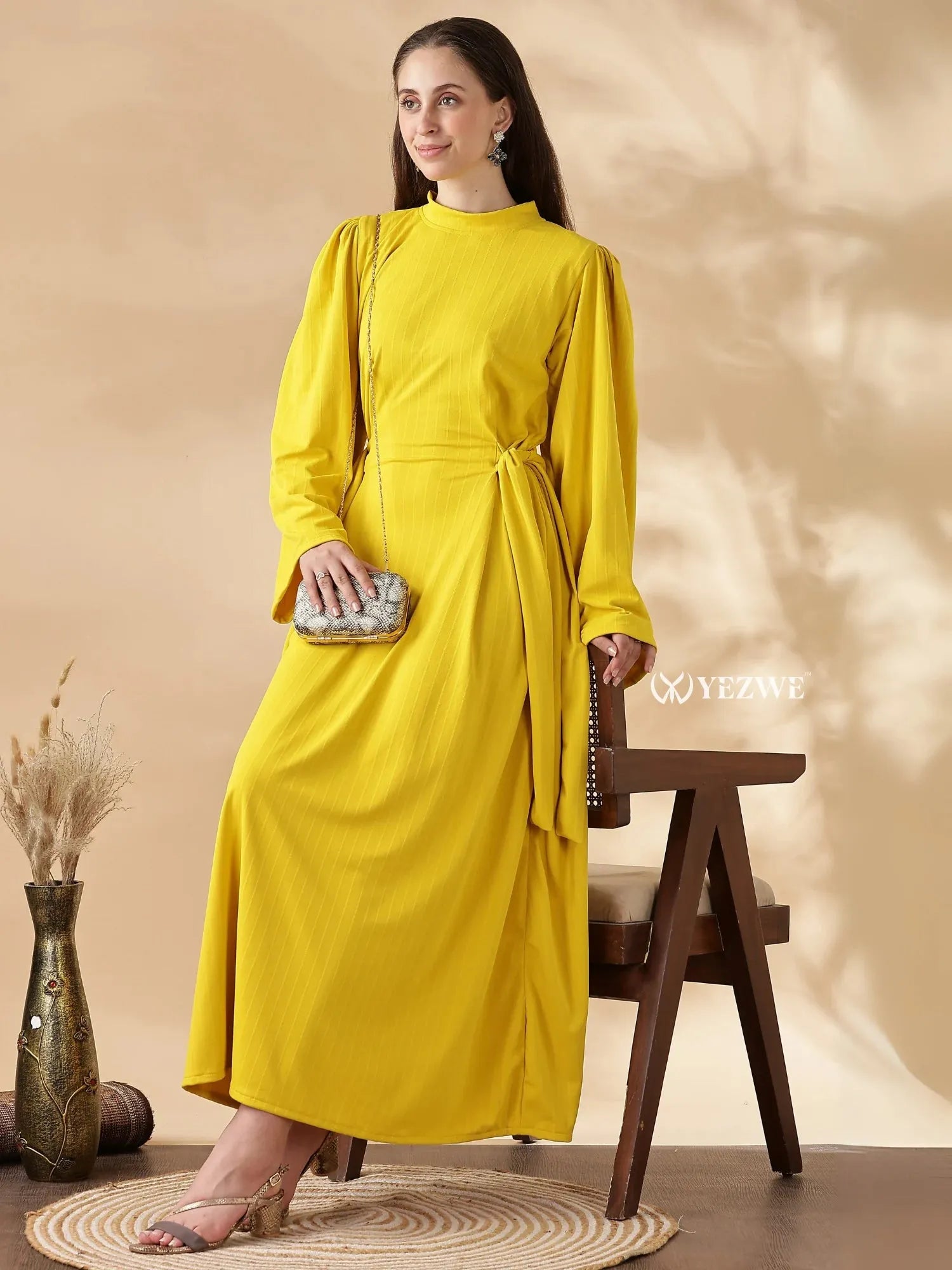 Modest yellow maxi dress by YEZWE featuring long sleeves and a stylish wrap detail for a sophisticated look