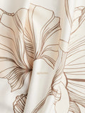 Close-up of Printed Ivory Kaftan featuring floral design and YEZWE branding on soft fabric