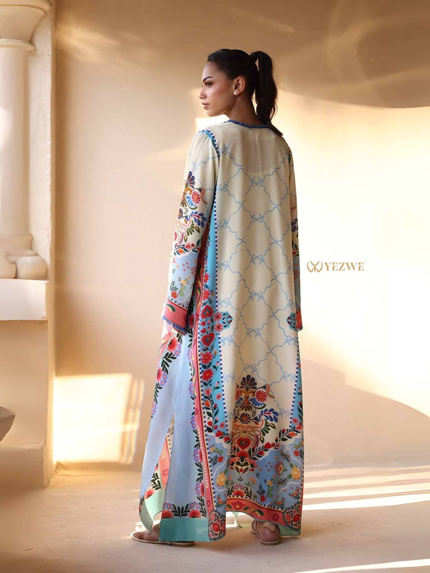 YEZWE Printed Maxi Kaftan tunic back view in cream and pastel blue with floral border print and long sleeves
