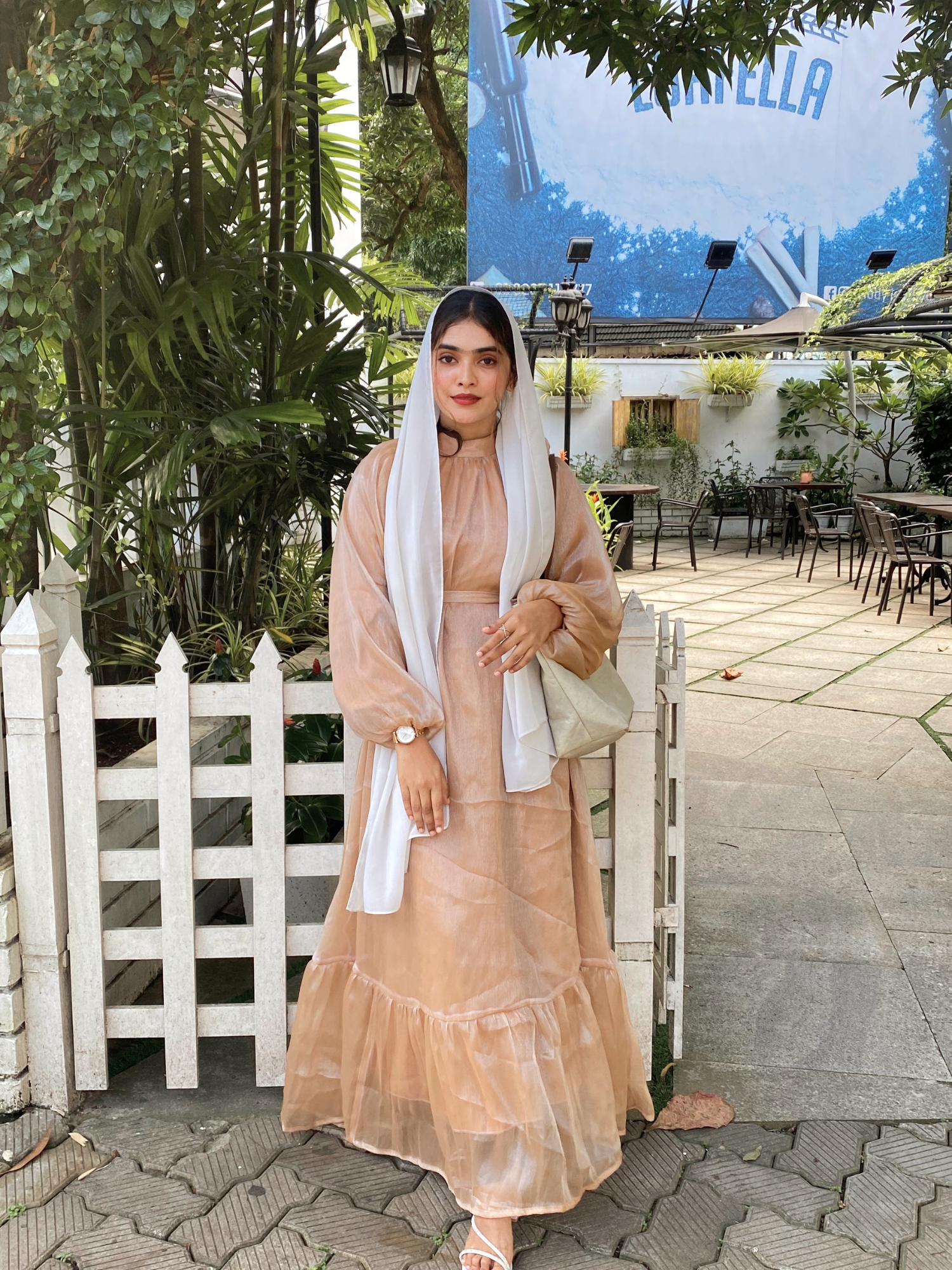 Woman wearing Yezwe Start Golden Beige Flare Maxi dress modest party wear with white headscarf outdoors
