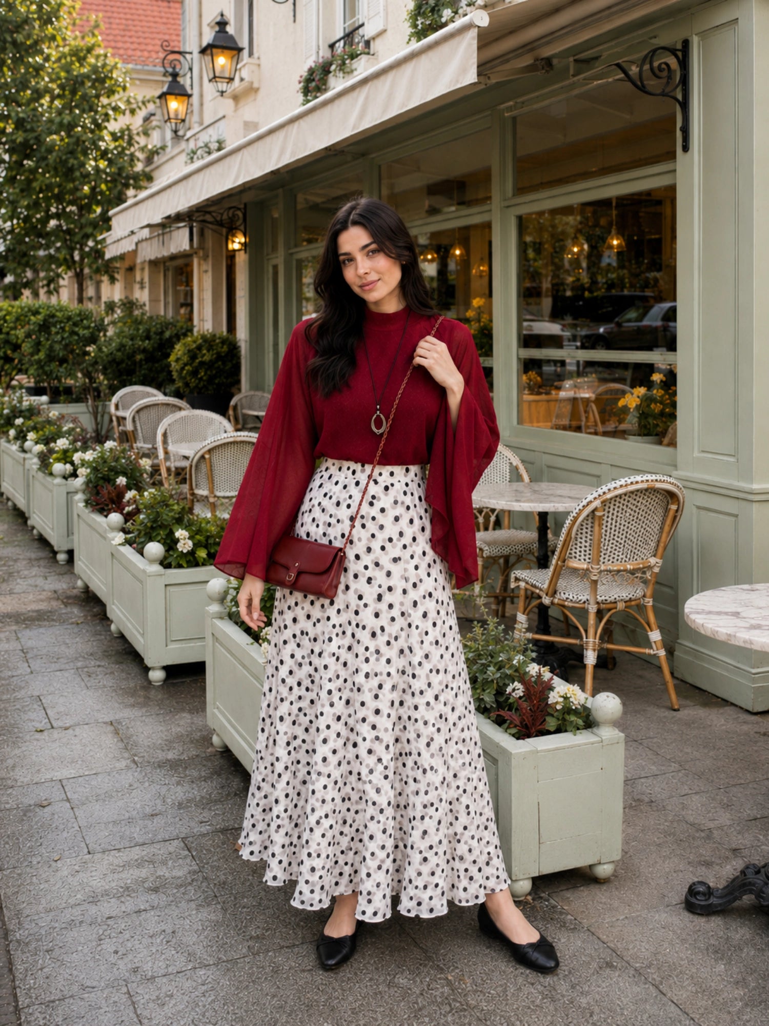 YEZWE Wine Red Fusion Mock-Neck Top & Polka Dot Co-ord Style Co ord with flowing skirt in an outdoor cafe setting 