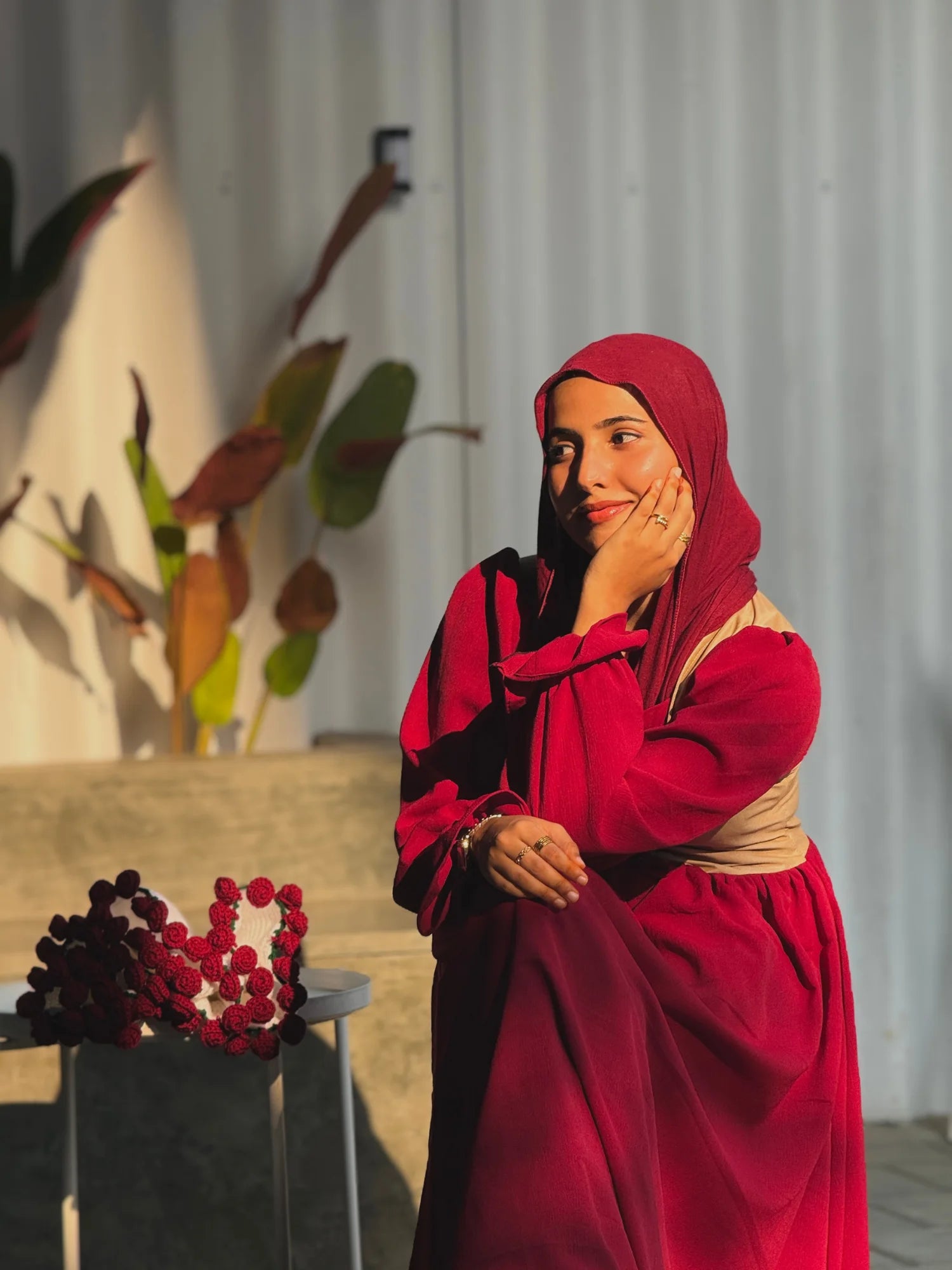 Woman wearing YEZWE Wine Red Modest Corset Lace Up Elegant Maxi Dress, sitting gracefully in sunlight