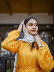 Yellow textured maxi dress by Yezwe featuring a relaxed fit and long sleeves, styled with a white headscarf