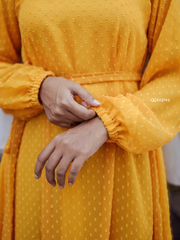 Close-up of sleeves on a yellow textured maxi dress by Yezwe, showcasing soft fabric and stylish design.